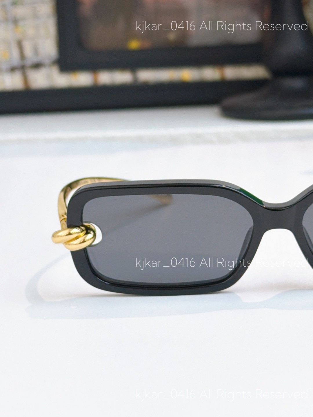 Bottega Veneta BV1439S Women’s Sunglasses Black Frame Gold Knot Gray Lenses