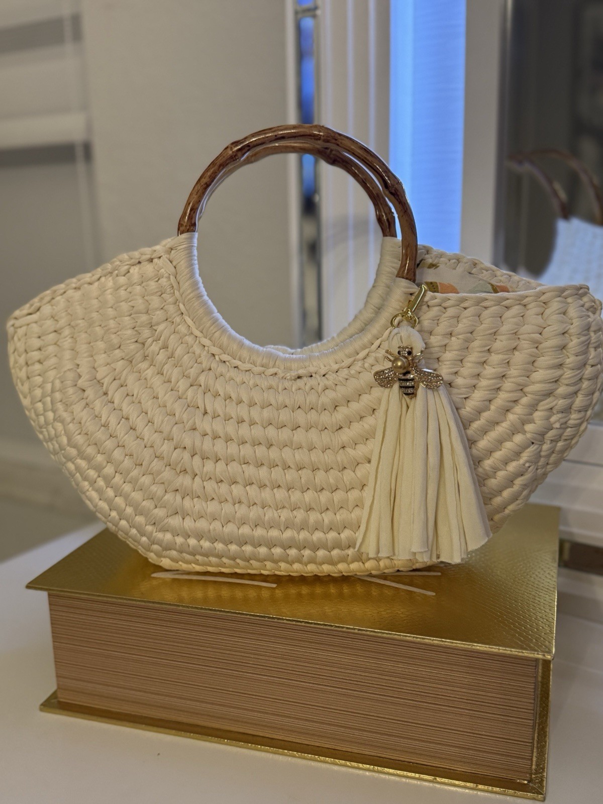 Ivory Woven Crescent Top Handle Bag Wood Handles Tassel Bee Charm Gold