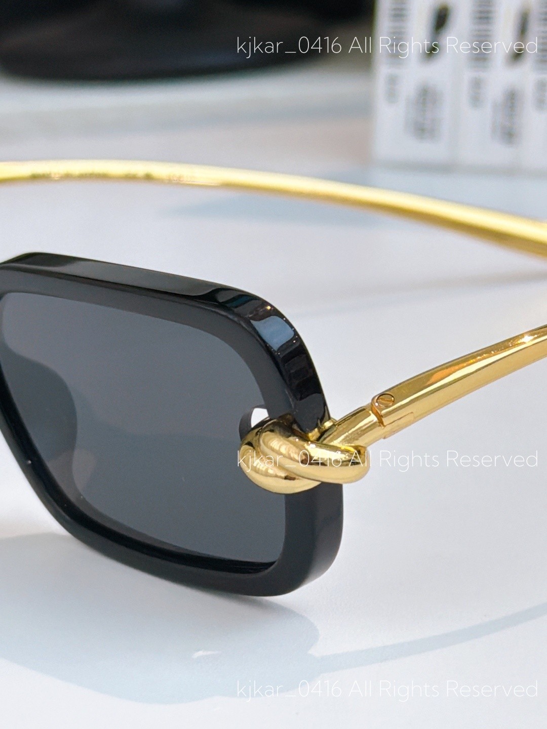 Bottega Veneta BV1439S Women’s Sunglasses Black Frame Gold Knot Gray Lenses